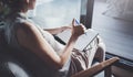 Young woman in casual clothes sitting at table in home and writing in notebook. Freelancer working home.