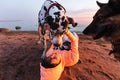 Thoughtful female owner with dog on coastline Royalty Free Stock Photo
