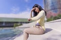 Young woman casual wearing looking at her watch while sitting