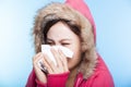 young Woman catch a cold and sneezing nose with a sweater. isolated on gray background