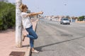 Young woman catches a car on the road, automatic stop, automatic braking, travel, travel