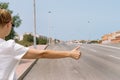 A young woman catches a car on the road close-up on her hand, automatic stop, automatic braking