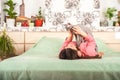 Young woman with cats having fun in the bedroom. Stay home concept. The girl with the cat Sphinx and Scottish Fold plays on the be Royalty Free Stock Photo