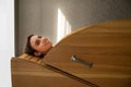 Young woman in cedar barrel. Spa and medical  procedures and treatment Royalty Free Stock Photo