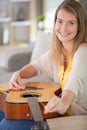 young woman changing guitar string