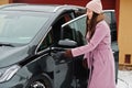 Young woman charging her electric car in winter Royalty Free Stock Photo