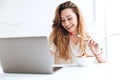 Young woman chatting on laptop and eating fruits Royalty Free Stock Photo