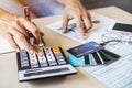 Young woman checking bills, taxes and calculating credit card expenses at home Royalty Free Stock Photo