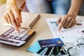 Young woman checking bills, taxes, bank account balance and calculating credit card expenses at home Royalty Free Stock Photo