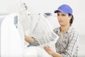 young woman checking and cleaning air conditioning system at home Royalty Free Stock Photo