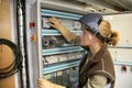 Young woman checking electrical instalations Royalty Free Stock Photo