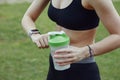 A young woman checking her progress on a smartwatch. Fitness sporty girl holding a bottle of water Royalty Free Stock Photo