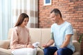 Young woman checking mature man`s pulse with medical device Royalty Free Stock Photo