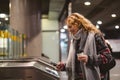 Young woman checking out at metro station