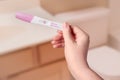 Young woman checking pregnancy test