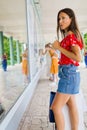 Young woman checking shop`s windows