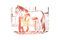 Young woman checking stallion horseshoe, equine care, female farmer in apron, purebred mare in stable