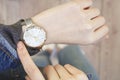 Young woman checking time her watch. Royalty Free Stock Photo