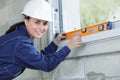 young woman checking wall with spirit level Royalty Free Stock Photo