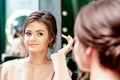 Young woman checks her hairstyle