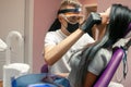 Young woman checks teeth in dental office. Male dentist examines