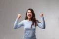 Young woman cheering in exultation