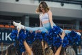 Young woman cheerleader doing a split, others holding her in the air Royalty Free Stock Photo