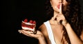 Young woman chef cook holding sweet piece cake with strawberry blueberry and cream show quiet shhh sign Royalty Free Stock Photo