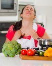 Young woman chef cooking with skeptical facial expressions, interacting frustrated body language Royalty Free Stock Photo