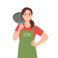 Young woman in chef hat with apron holding frying pan