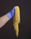 Young woman chef holds homemade pasta in the air over black background. Creative idea. Italian cuisine concept Royalty Free Stock Photo