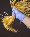 Young woman chef holds homemade pasta in the air over black background. Creative idea. Italian cuisine concept Royalty Free Stock Photo