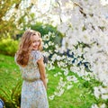 Young woman in cherry blossom garden