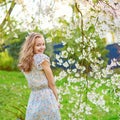 Young woman in cherry blossom garden