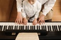 Young woman with child playing piano. Music lesson Royalty Free Stock Photo