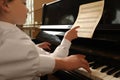 Young woman with child playing piano, closeup. Music lesson Royalty Free Stock Photo