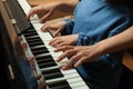 Young woman with child playing piano, closeup. Music lesson Royalty Free Stock Photo