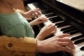 Young woman with child playing piano. Music lesson Royalty Free Stock Photo