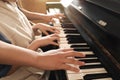 Young woman with child playing piano. Music lesson Royalty Free Stock Photo