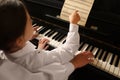 Young woman with child playing piano, closeup. Music lesson Royalty Free Stock Photo