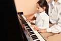 Young woman with child playing piano. Music lesson Royalty Free Stock Photo