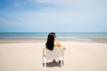 Young women chill out and sitting by the sea beach to get the sun tan with amazing view. Tropical travel vacation or holiday Royalty Free Stock Photo