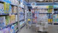 Hygiene products for children. Young mother chooses diapers in the supermarket in the mall. Tomsk, Russia 2022 Royalty Free Stock Photo