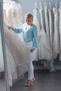 Young woman chooses a wedding dress in the store Royalty Free Stock Photo