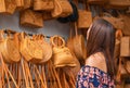 A young woman chooses a wicker bag in the store. Asian braided bags. Close up