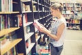 Woman choosing a book to buy in bookstore