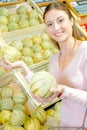 Young woman choosing cantaloup