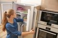 Young woman choosing food in refrigerator Royalty Free Stock Photo