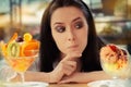 Young Woman Choosing Between Fruit Salad and Ice Cream Desserts Royalty Free Stock Photo