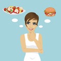 Young woman choosing between hamburger and salad. Healthy and junk food concept Royalty Free Stock Photo